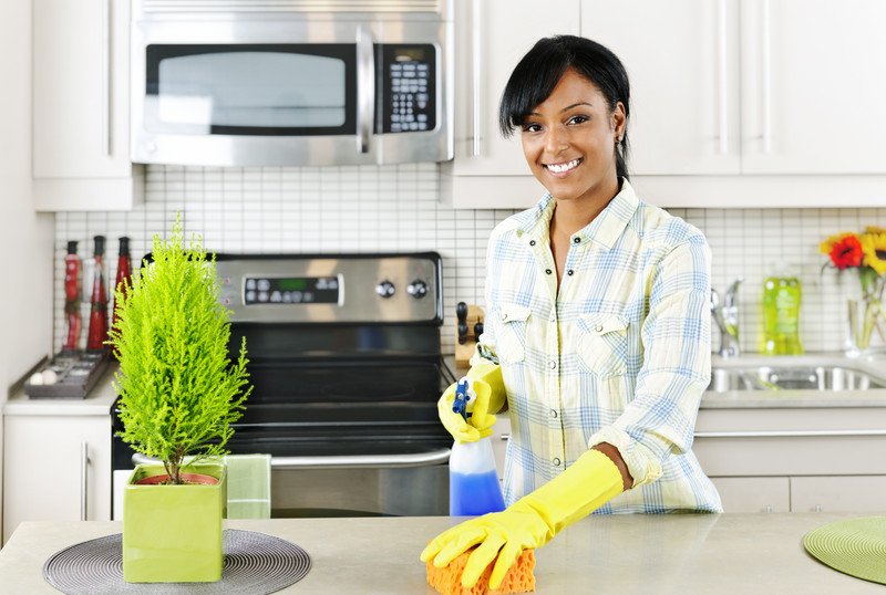 Glendale Cleaning Services team member wiping cabinets
